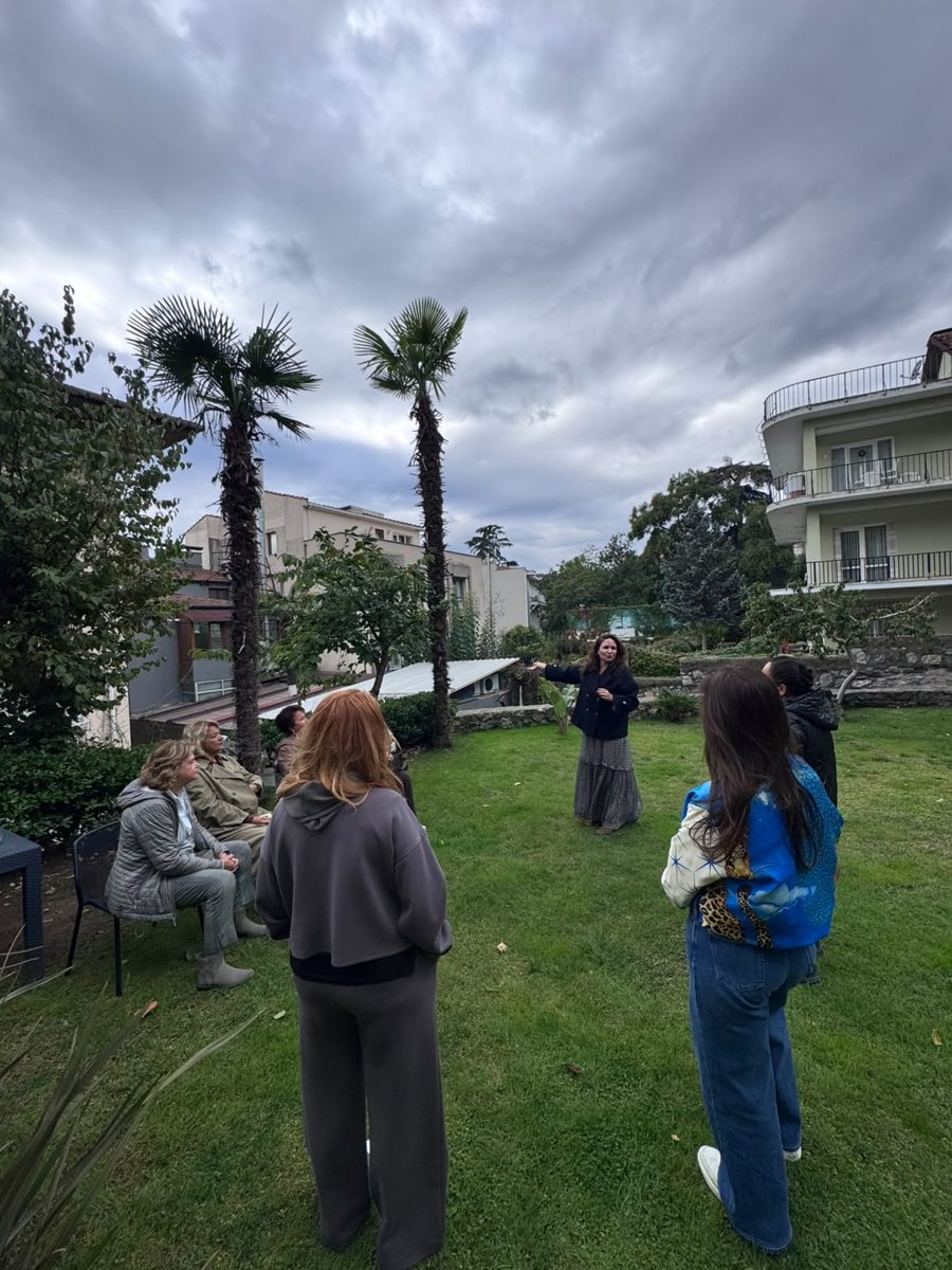 Guests standing in the garden during the healing meditation guided by Merve Tüfekçi